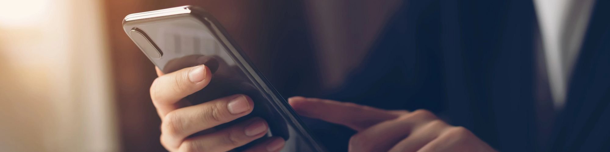 Person Using Their Phone from King Carpet Plus in Plainview