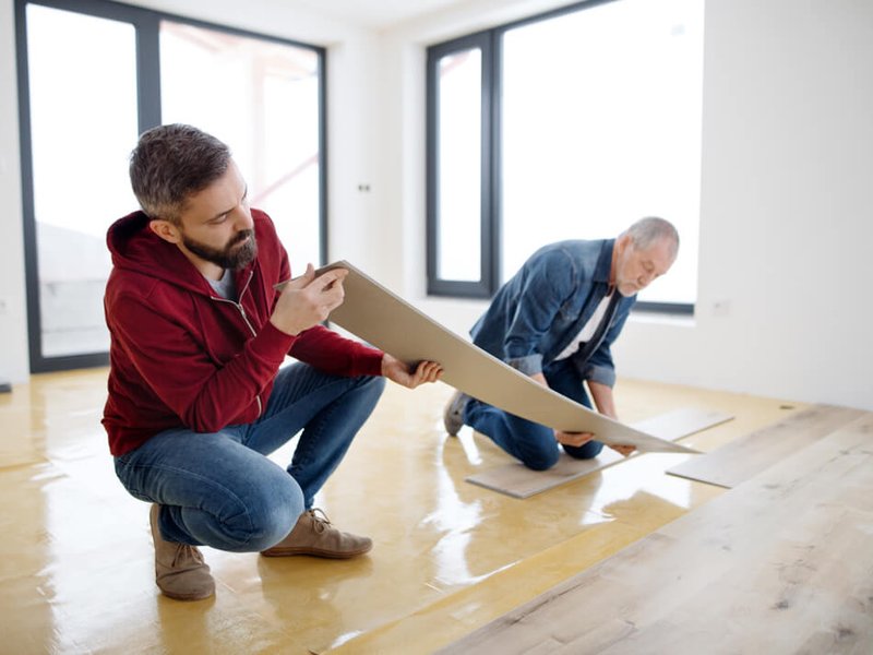 person installing a vinyl sheet